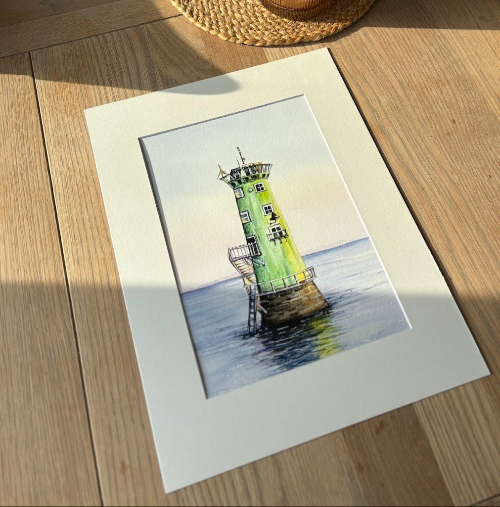 Art print of a lighthouse on a wooden surface